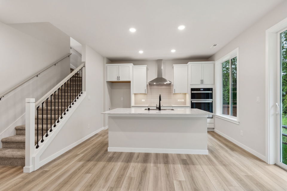A white kitchen with a white tub.
