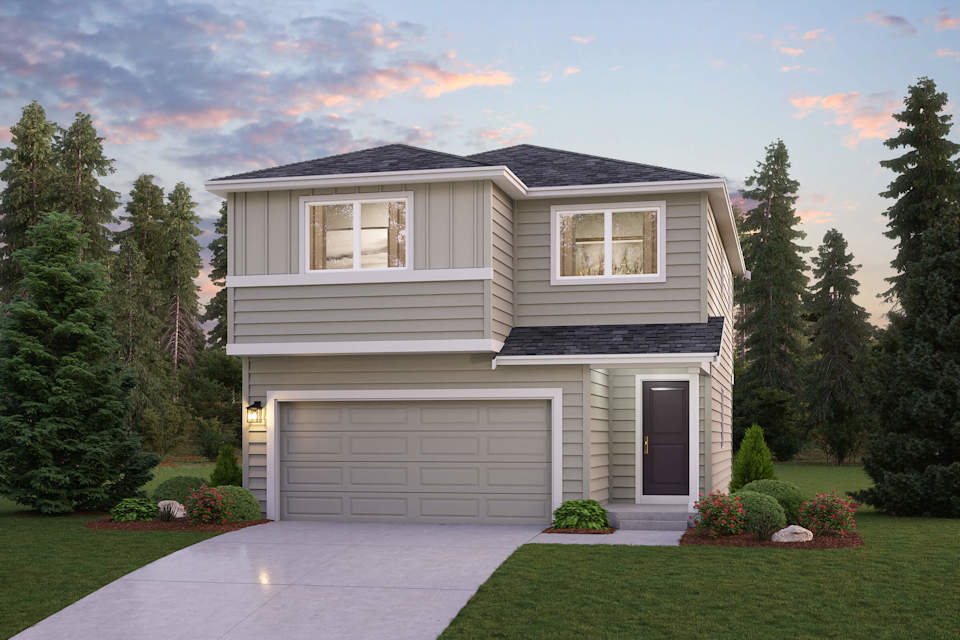 A house with a garage and trees around it.