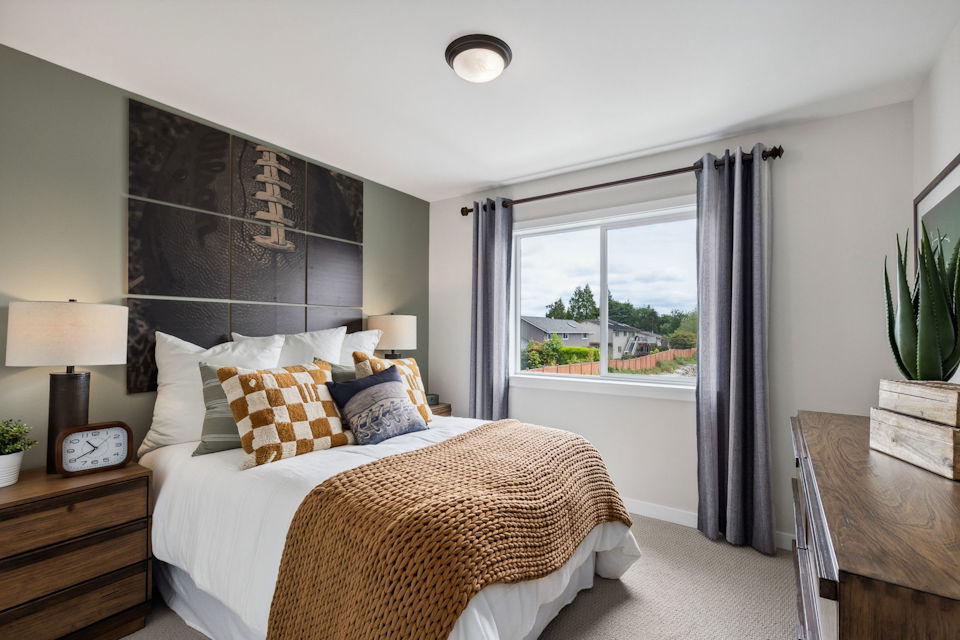 A bedroom with a large window.