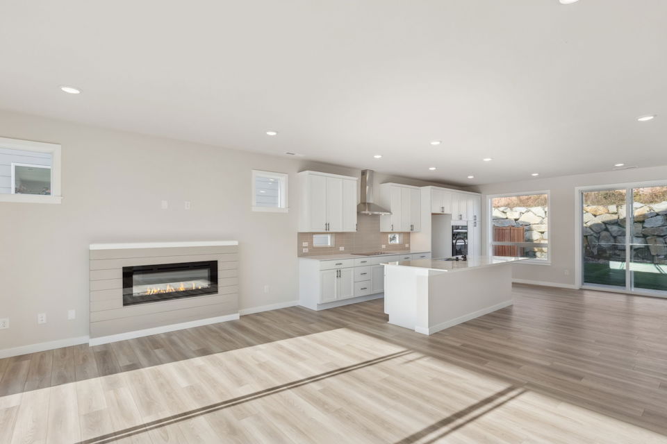 A kitchen with a fireplace.
