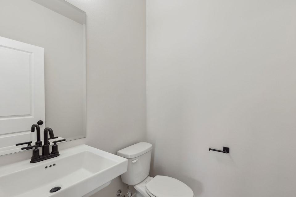 A bathroom with a toilet and sink.