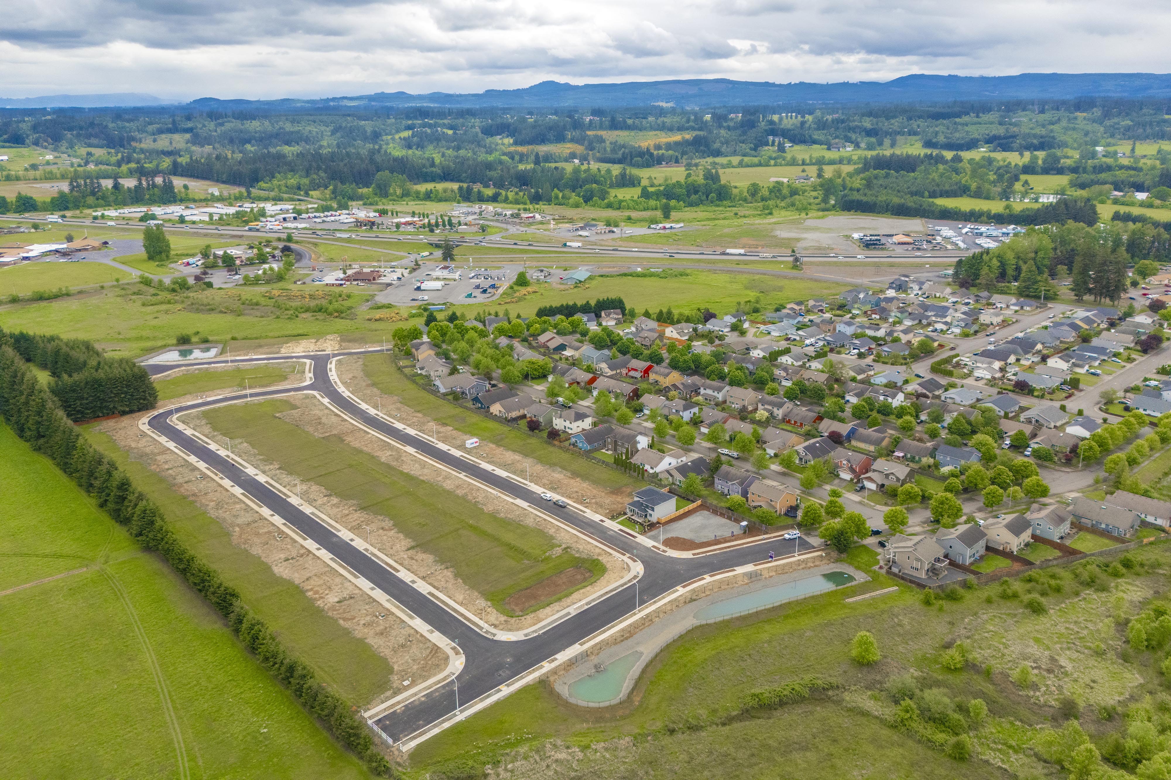 A landscape with a river and buildings.