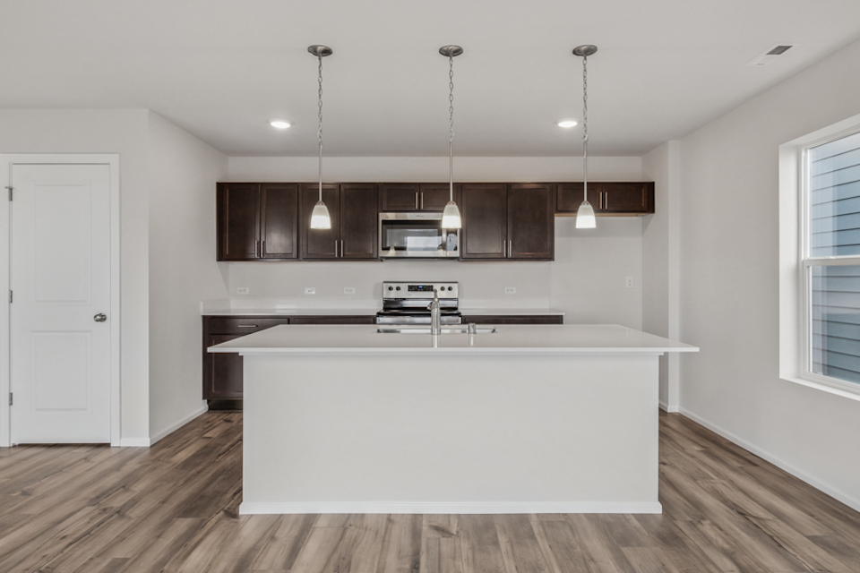 A kitchen with a white counter top.