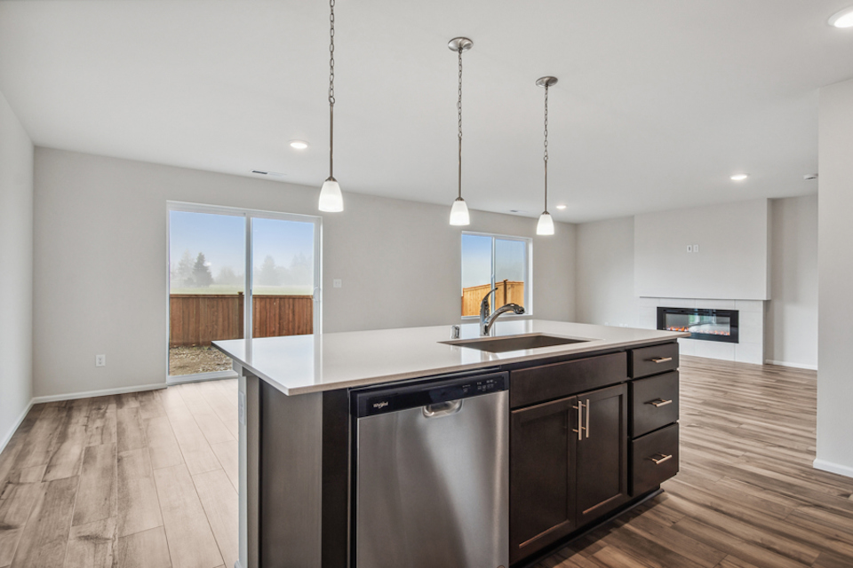 A kitchen with a sink and a refrigerator.