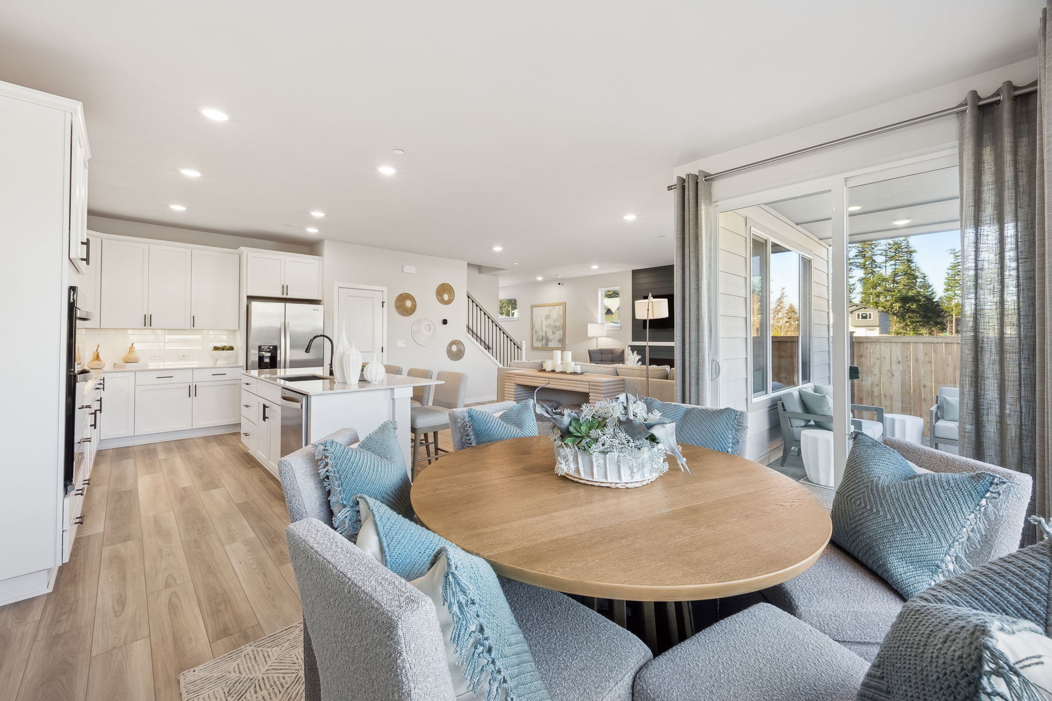 A large kitchen with a dining table.