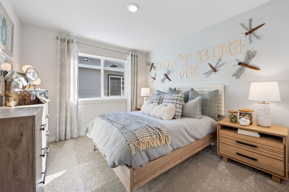 A bedroom with a bed and a window.