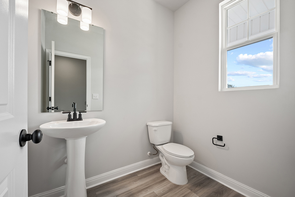 A bathroom with a toilet and sink.