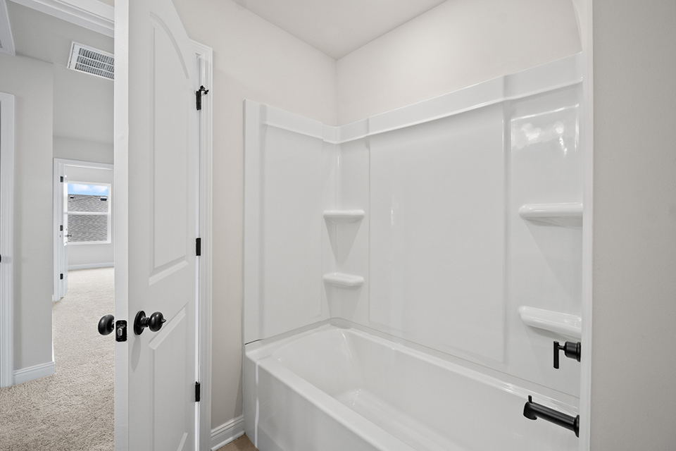 A bathroom with a bathtub and toilet.