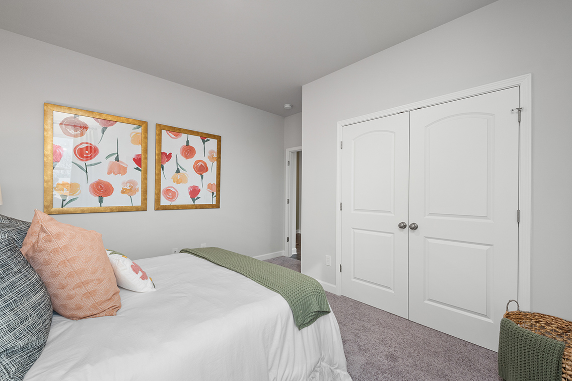 A bedroom with a bed and a door.