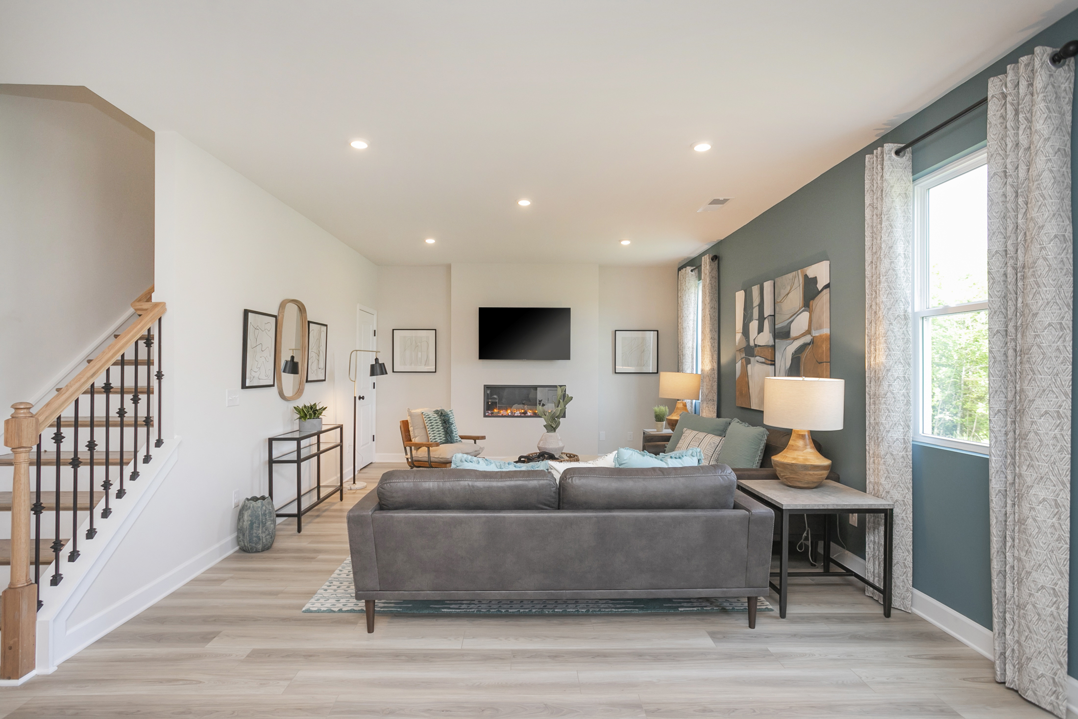 A living room with a large staircase.