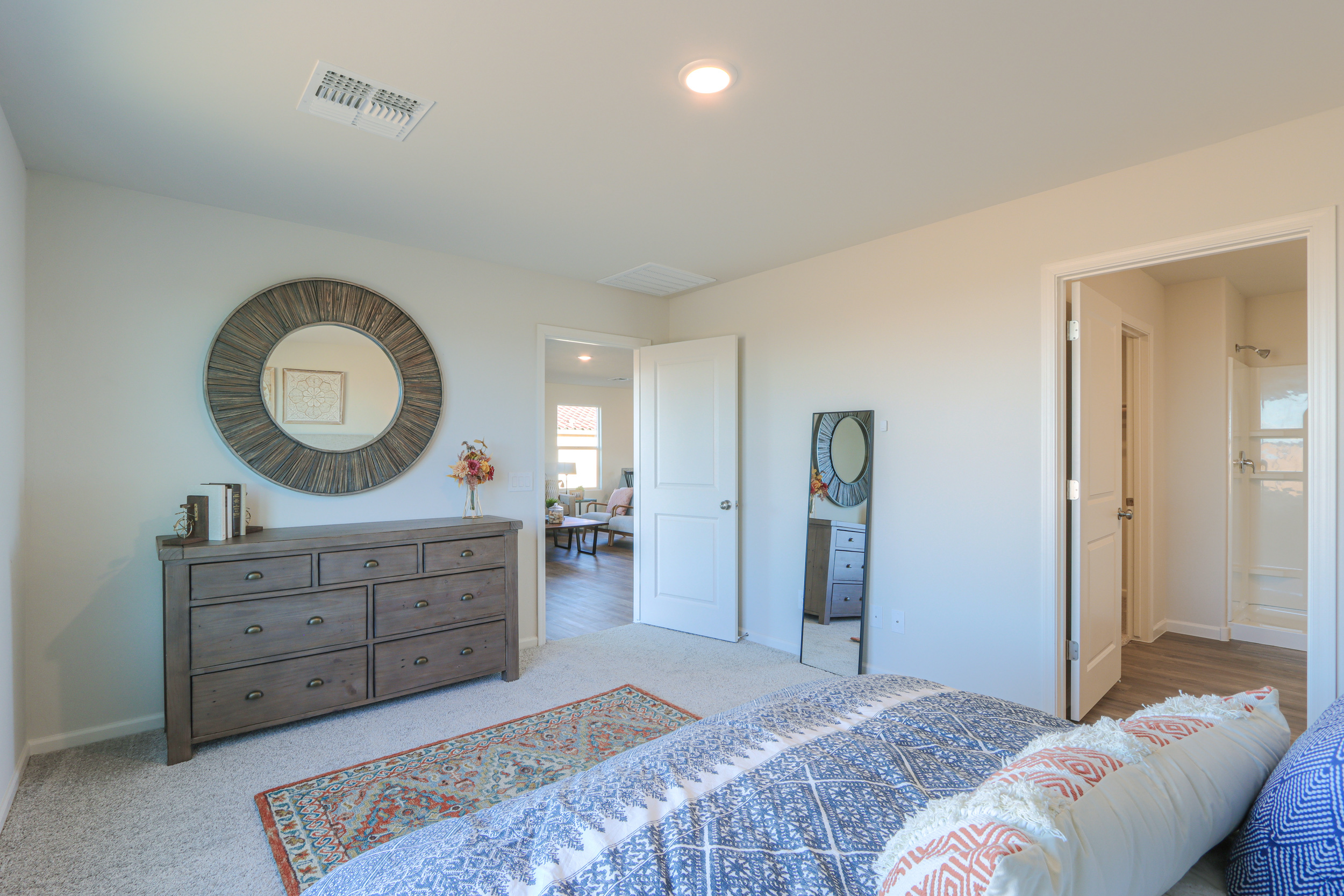 A bedroom with a bed and dresser.