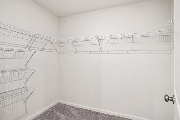 A white wall with a metal railing.