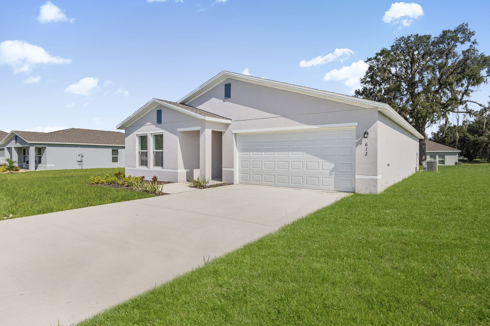 A white house with a driveway.
