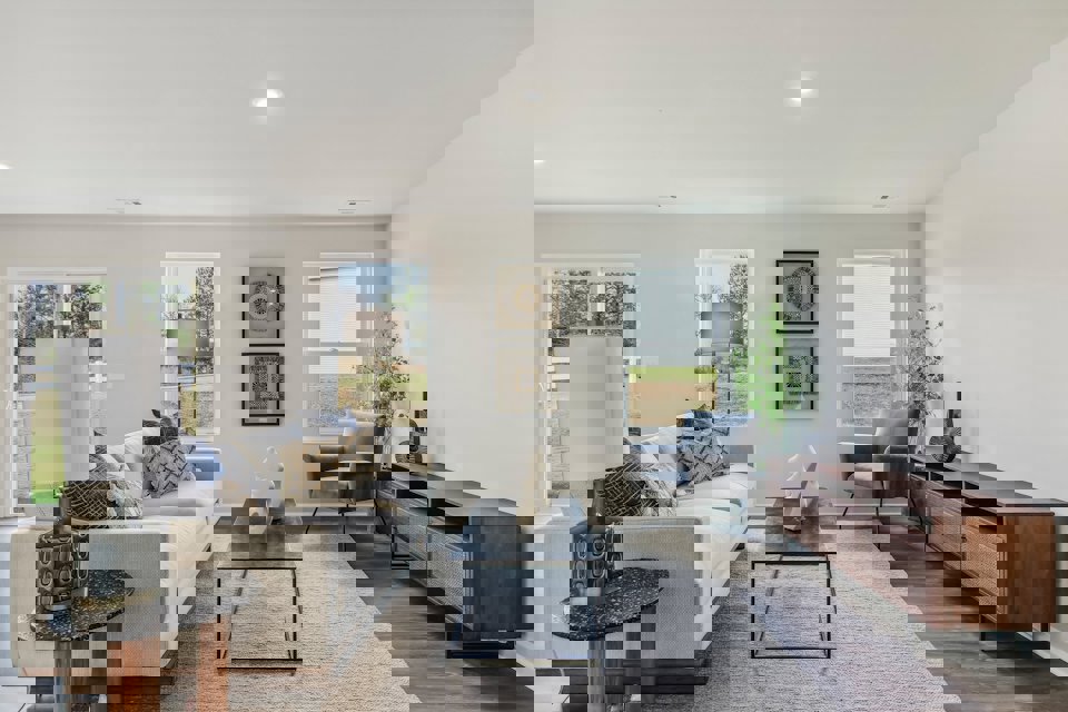 A living room with a couch and a table.