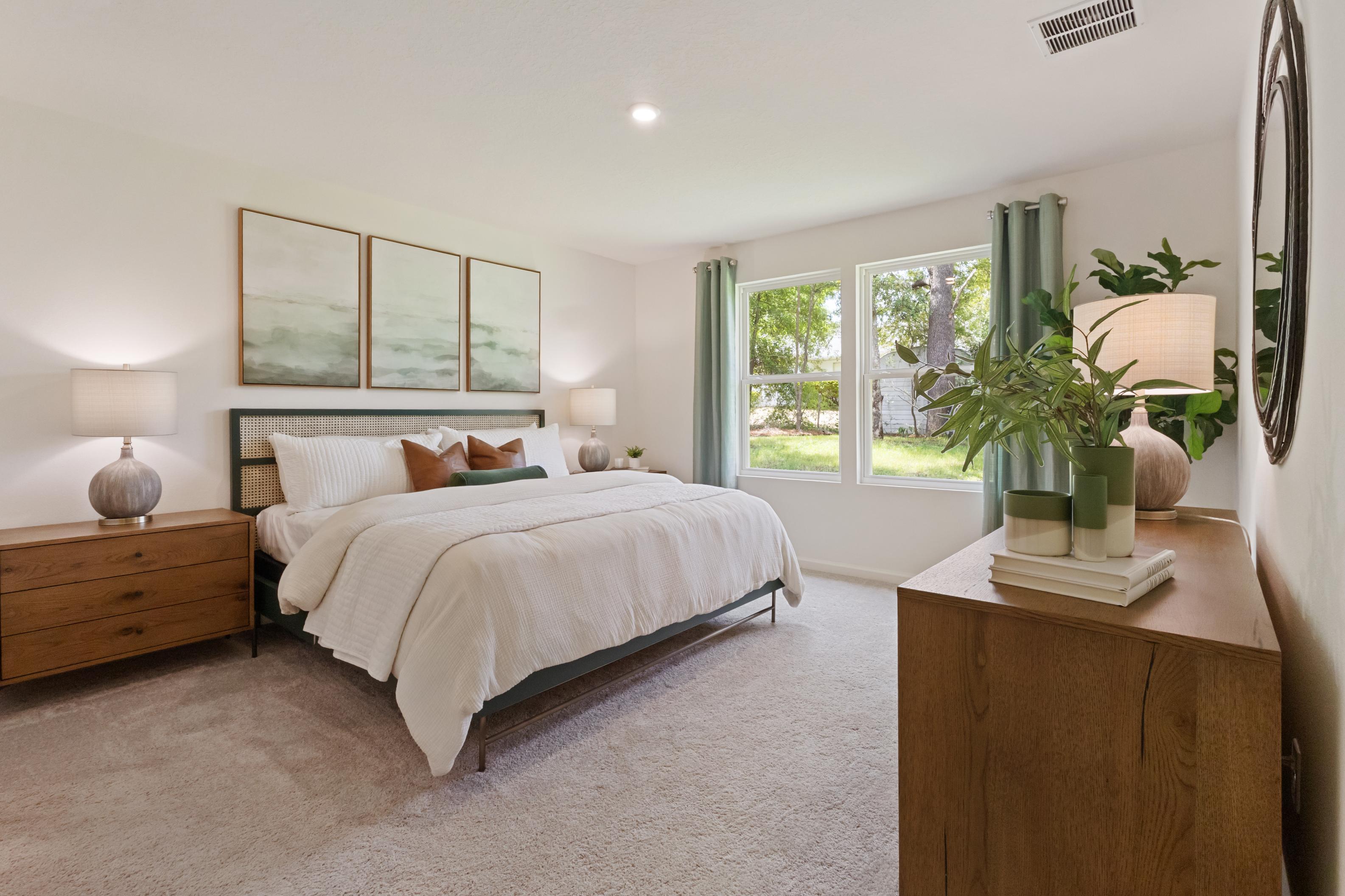 A bedroom with a bed and a window.