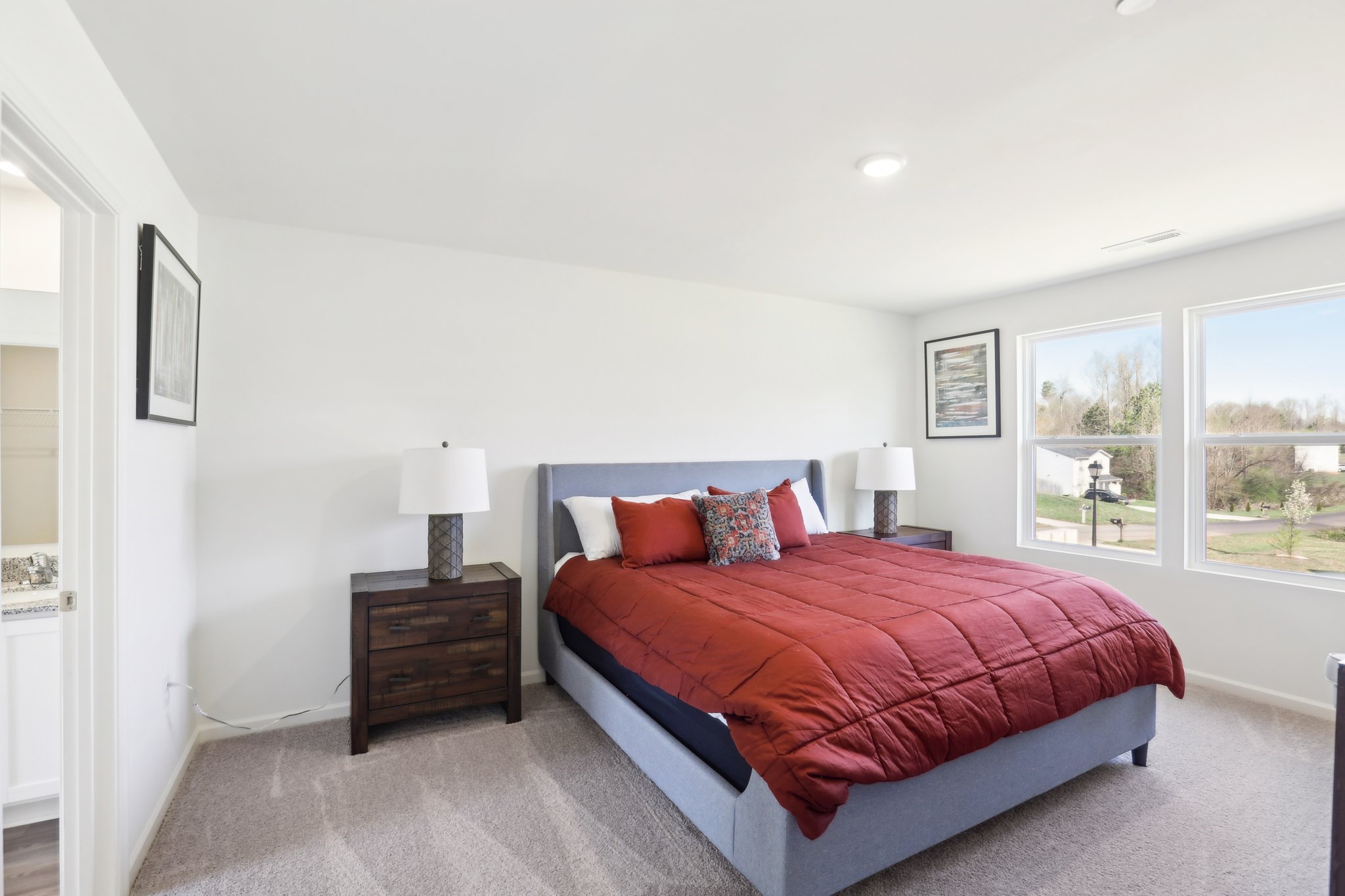 A bedroom with a red bed.