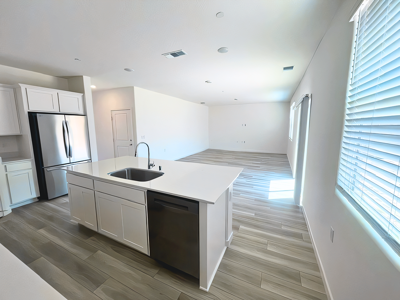 A kitchen with white cabinets.