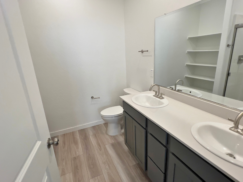 A bathroom with a sink and a toilet.