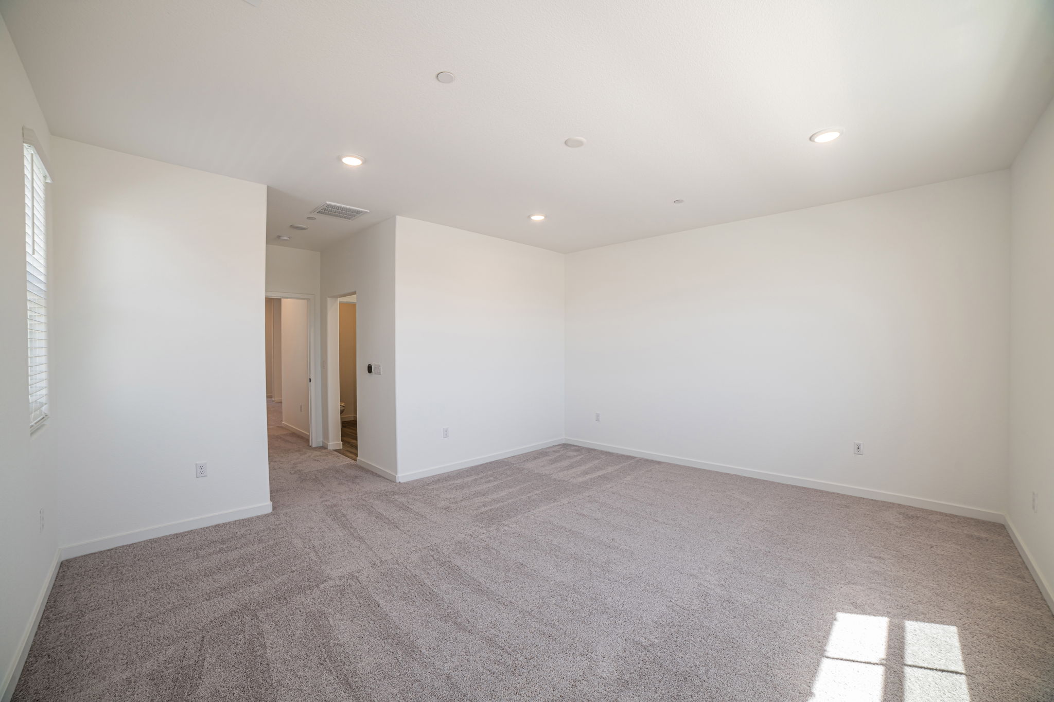 A long hallway with white walls.
